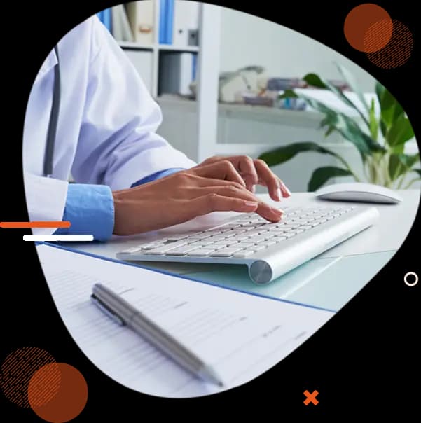 Medical records specialist typing at a desk