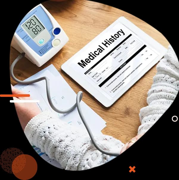 Blood pressure monitor and a medical history form on a tablet