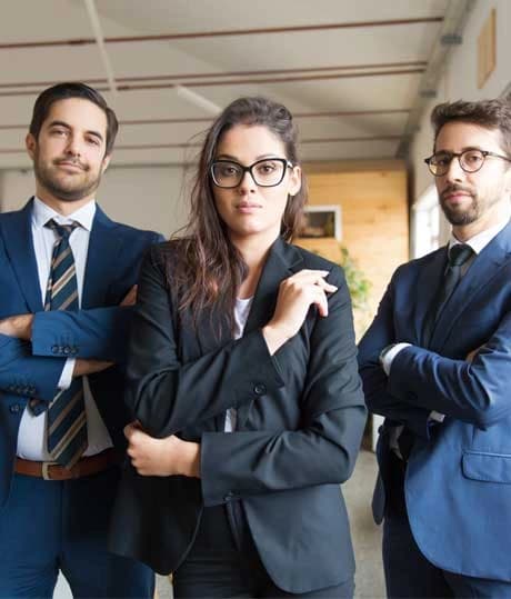 Three legal professionals standing in an open-plan office